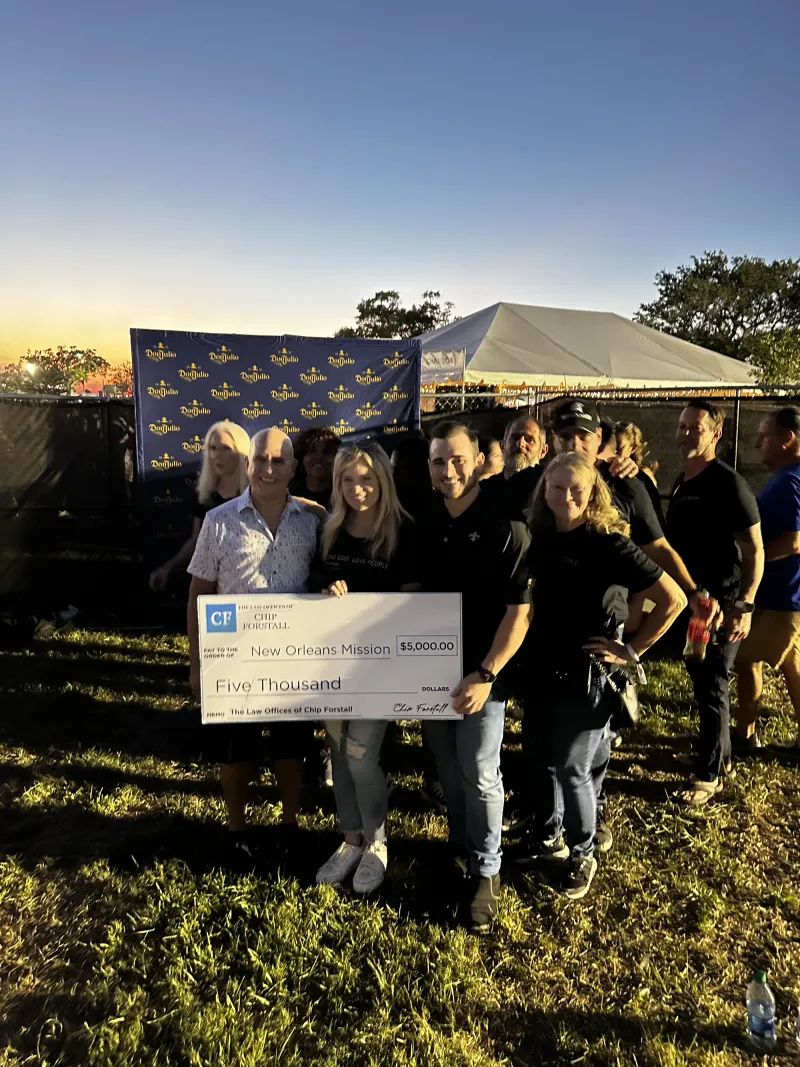 The firm presenting a donation check to the New Orleans Mission