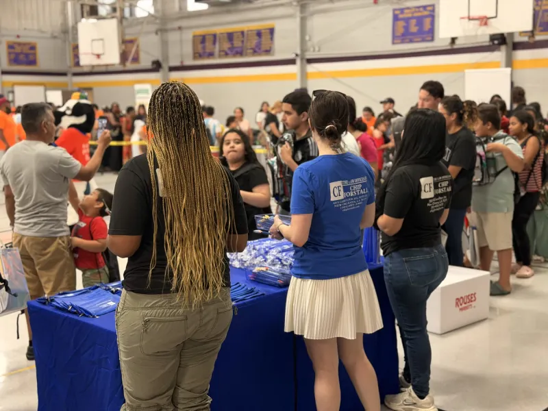 Forstall team members handing out supplies at a community giveaway table