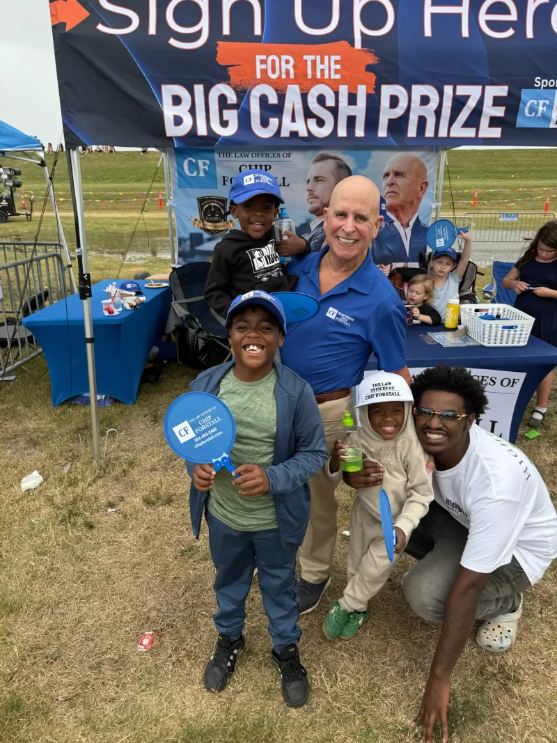 Under a tent at a neighborhood event with local children