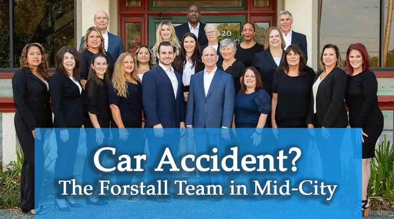 whole team of people outside of the Chip Forstall Law Firm Mid-City Building