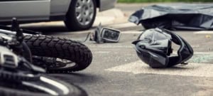 photo of motorcycle crash with car accident - motorcyle ties and helmet