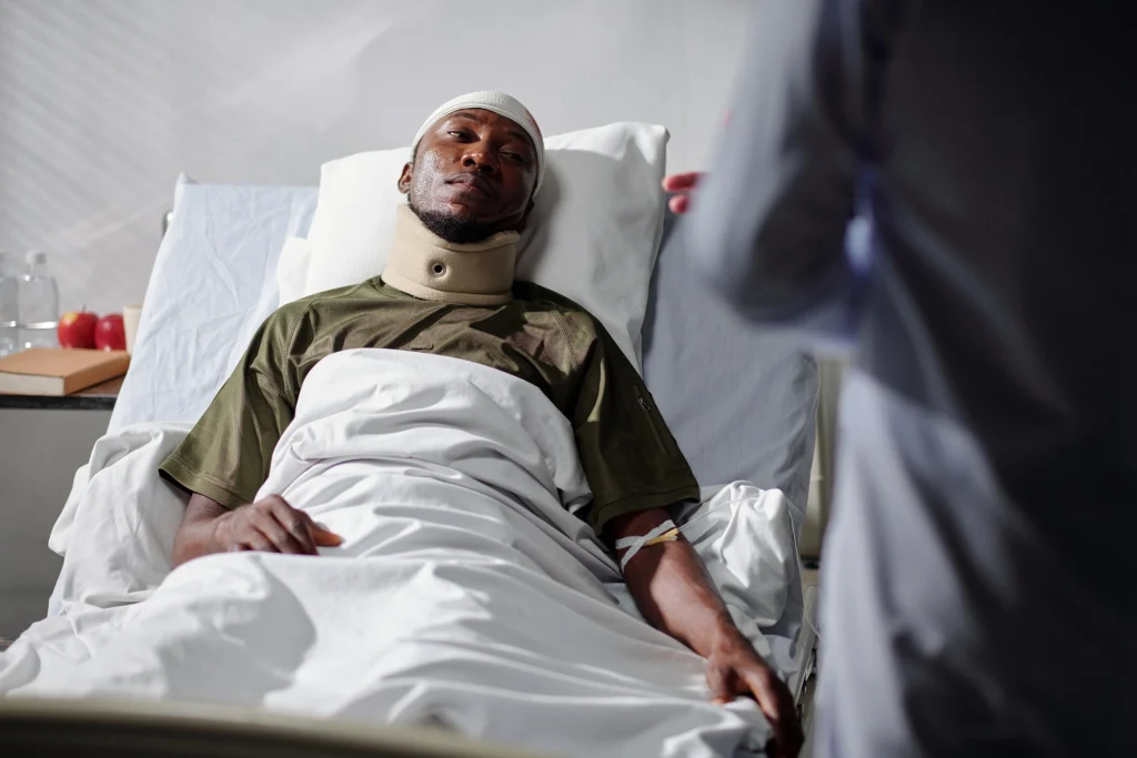 Hospital patient with neck brace lying in bed after a serious accident for wrongful death and personal injury legal representation