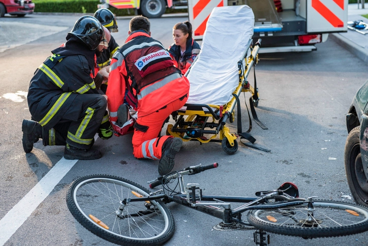 Emergency responders assisting injured cyclist after a bicycle accident in New Orleans