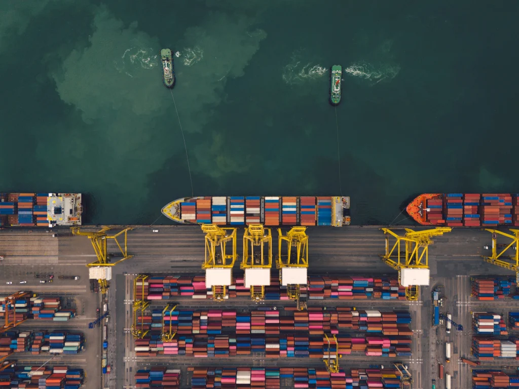 Aerial view of container vessels and cargo operations at a maritime new orleans shipping port, representing maritime injury and offshore workplace accident claims.